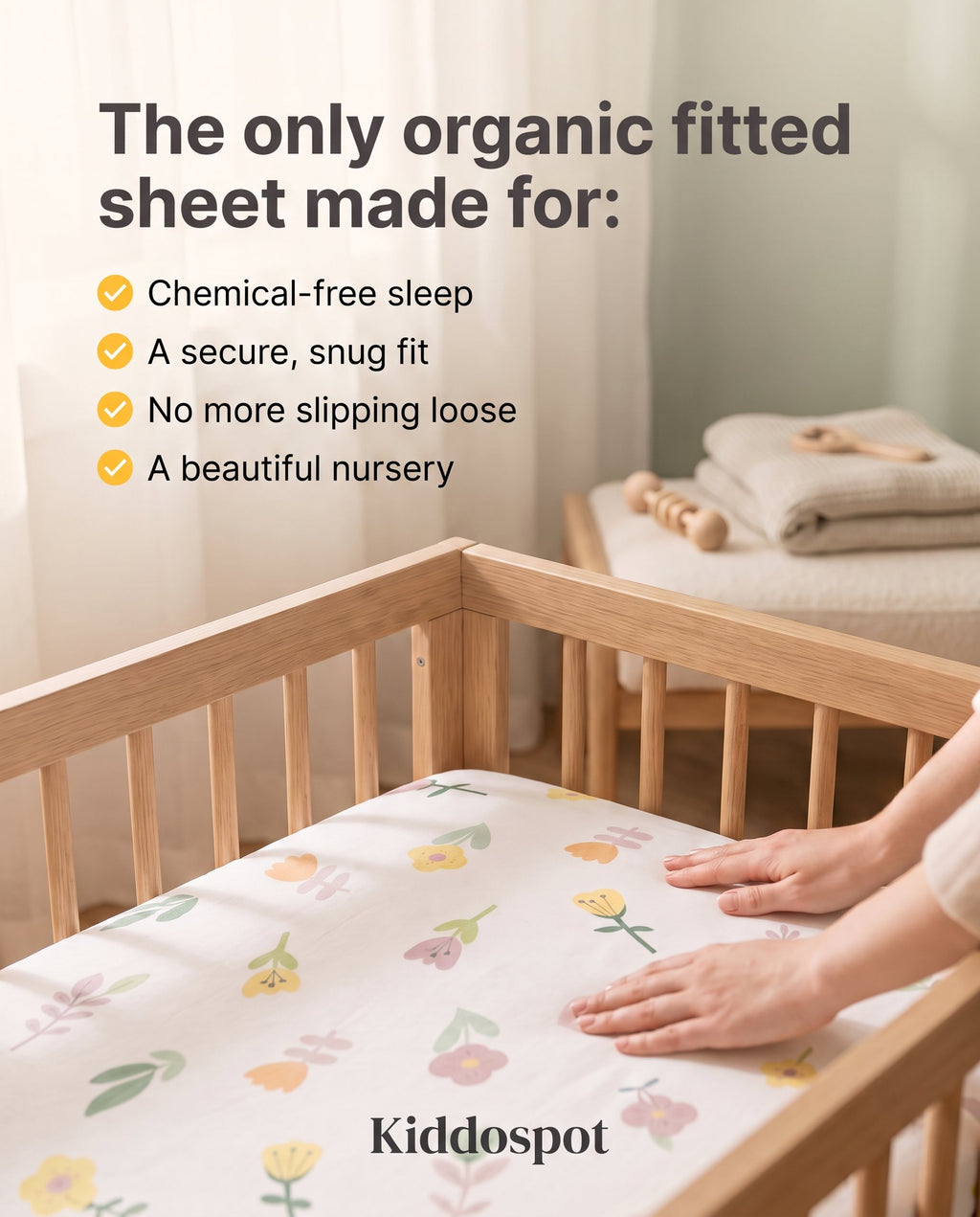 Kiddospot's organic cotton cot fitted sheet with flower pattern on a baby cot. 