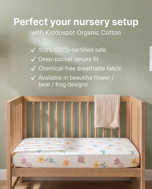 Kiddospot's organic cotton cot fitted sheet with flower pattern on a baby cot. 