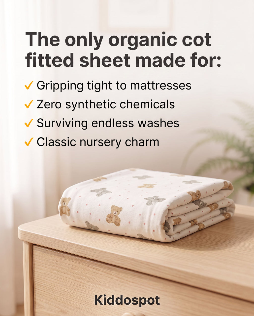 Kiddospot's organic cotton fitted sheet folded on a nursery table.