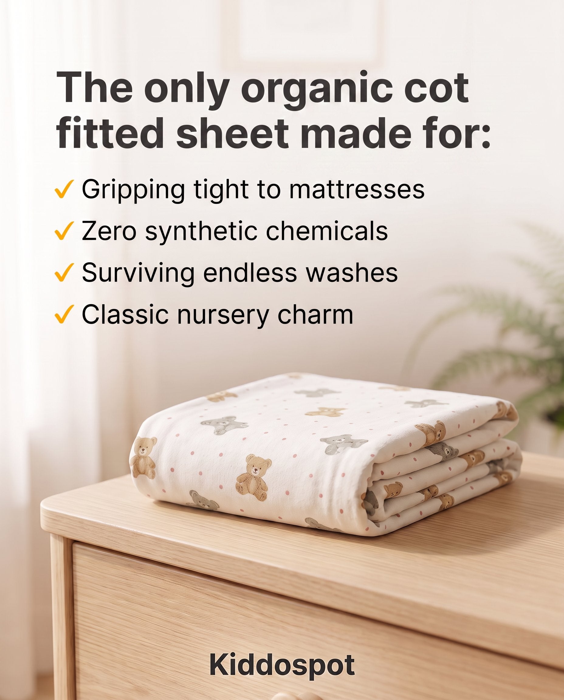 Kiddospot's organic cotton fitted sheet folded on a nursery table.