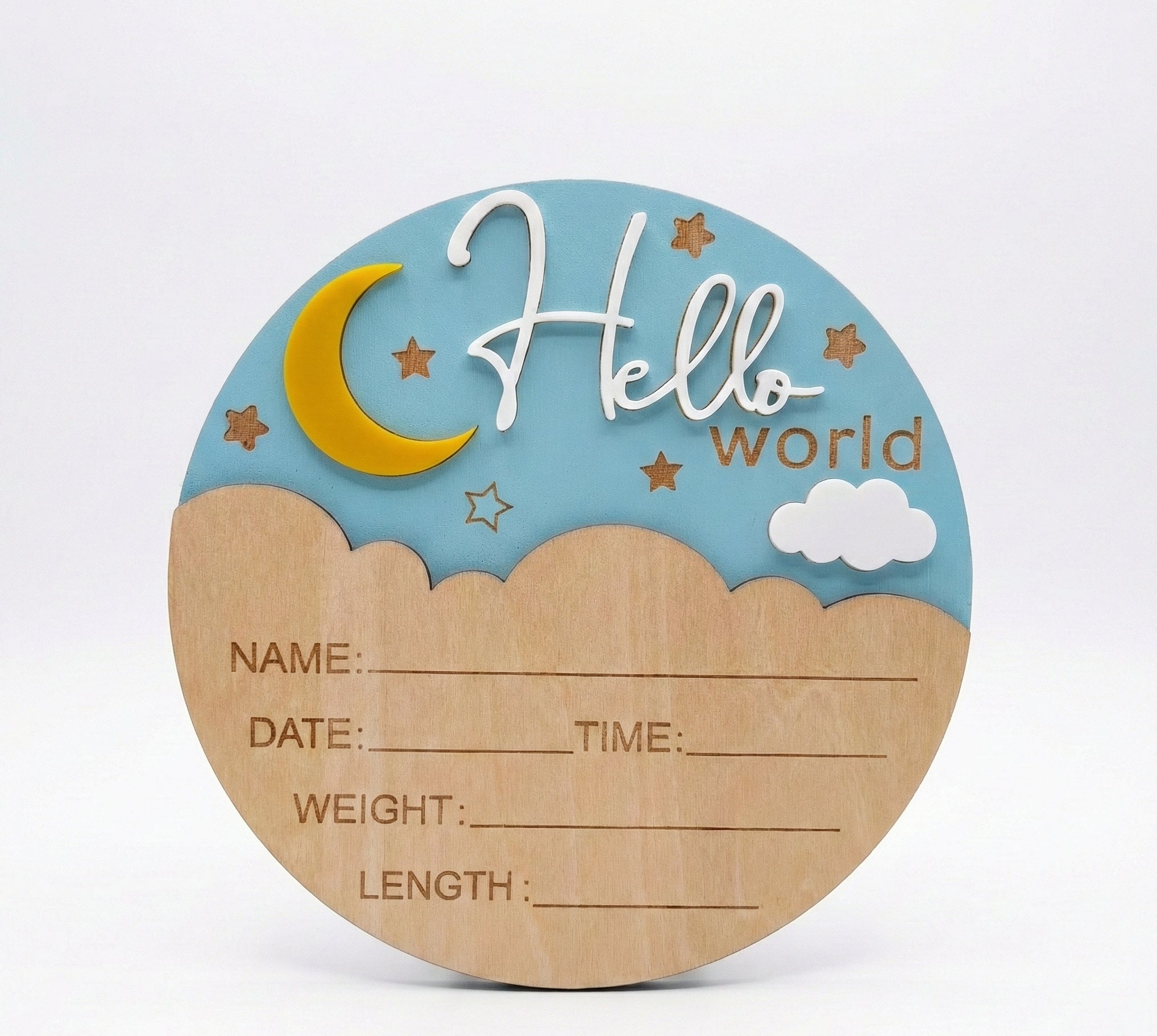 Round wooden plaque with 'Hello world' text, moon, stars, and clouds on a blue background.