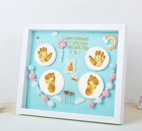 Baby milestone shadow box with hand and footprints on a light blue background