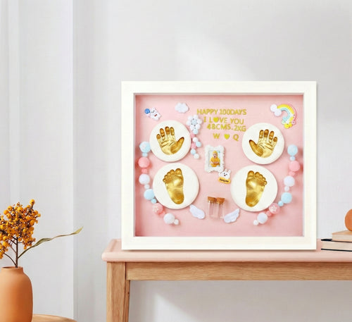 Kiddospot pink baby handprint footprint frame displayed on wooden surface — nursery keepsake