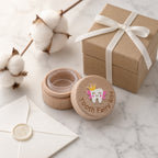 Kiddospot Deluxe Wooden Tooth Fairy Box — solid beechwood cylindrical box with a decorative envelope and cotton branches on a marble surface