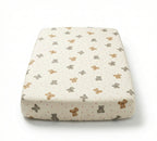 Baby changing pad with teddy bear pattern on a white background