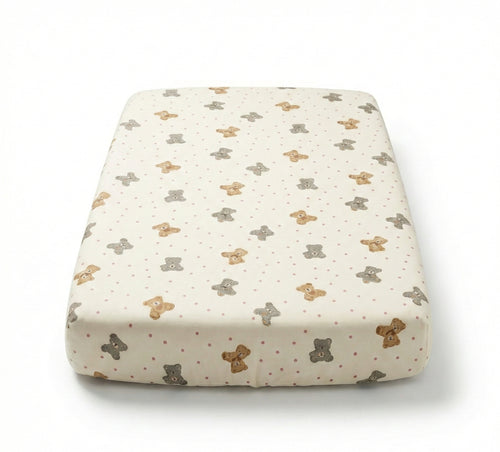 Baby changing pad with teddy bear pattern on a white background
