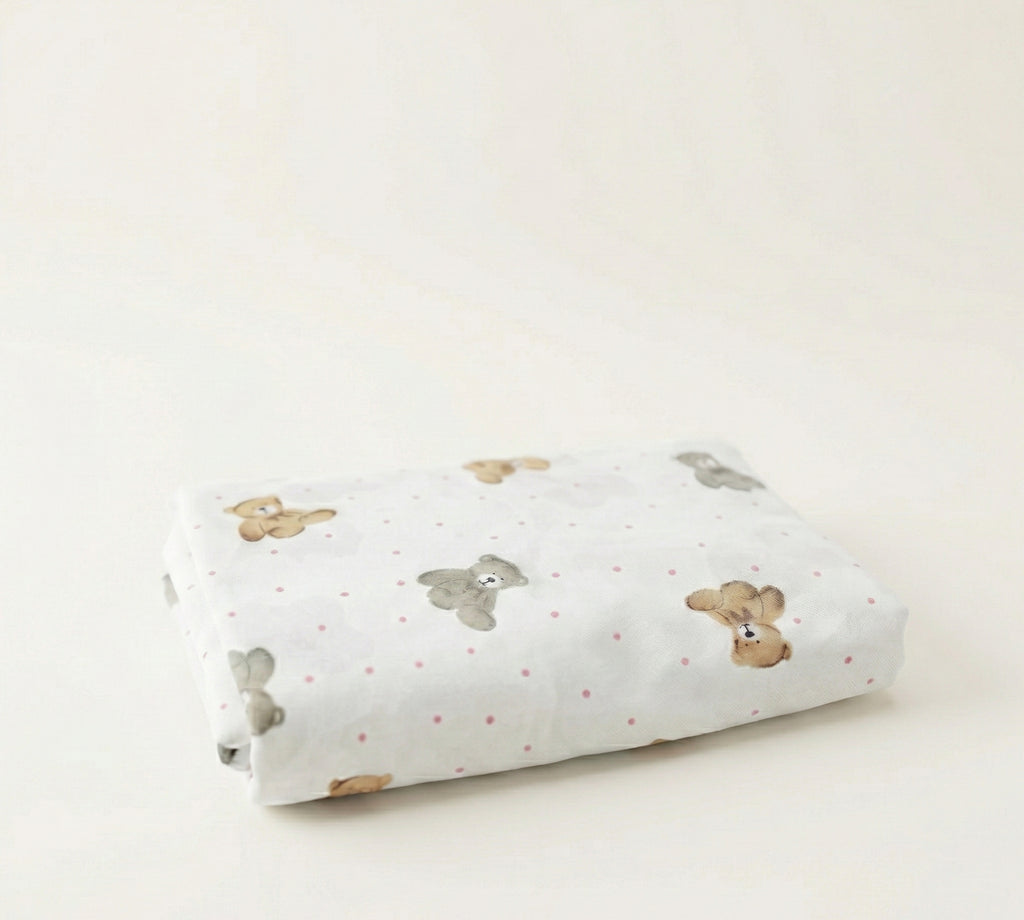 Rolled-up fabric with teddy bear pattern on a light background