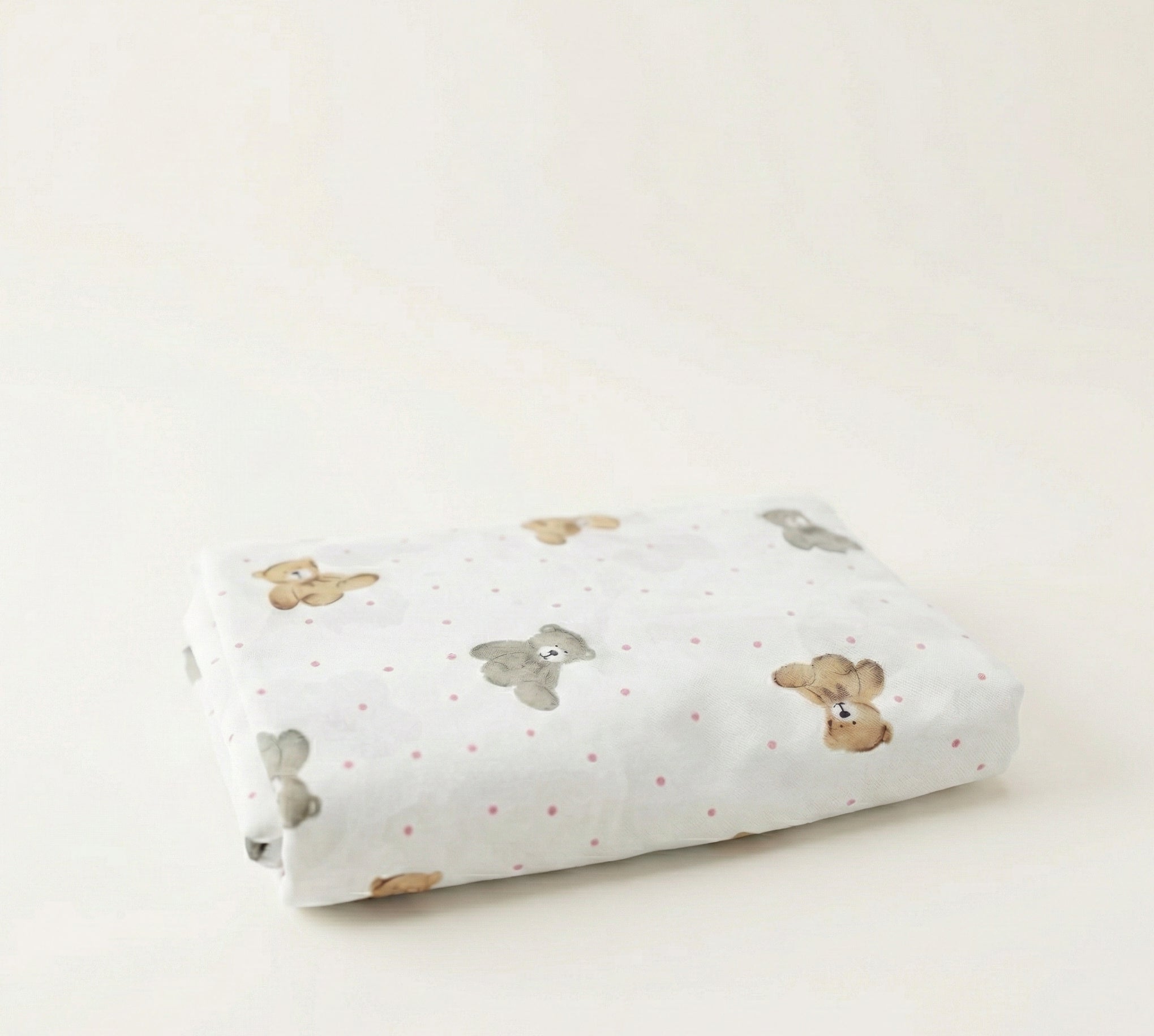 Rolled-up fabric with teddy bear pattern on a light background