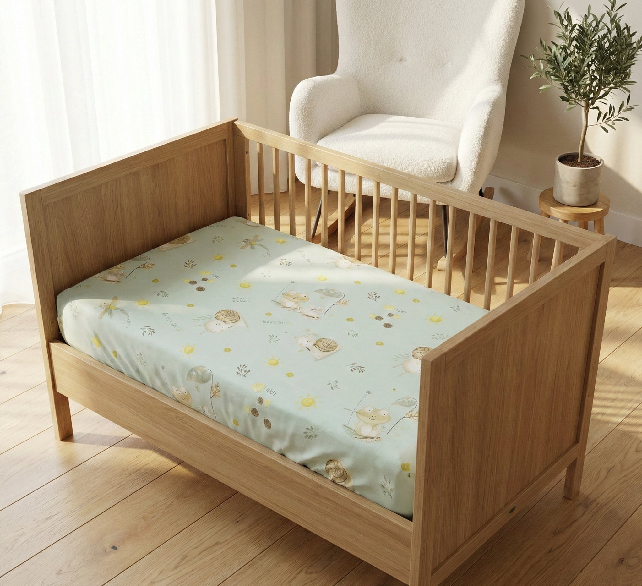 Wooden crib with a floral mattress cover in a room with a chair and plant.