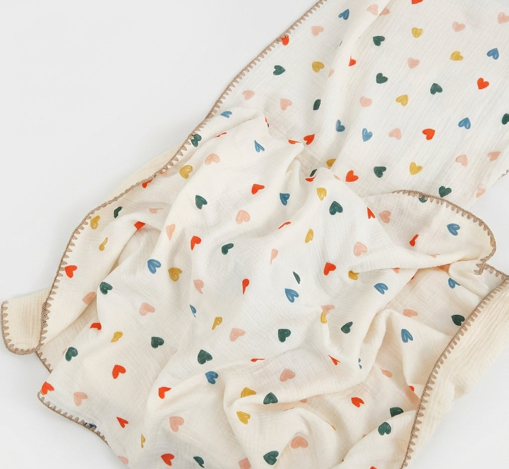 Baby blanket with colorful heart pattern on a white background