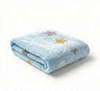 Folded blue blanket with star patterns on a white background