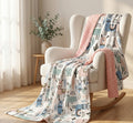 Rocking chair with a patterned blanket draped over it in a room with curtains and a plant.