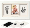 Baby hand and foot print frame with photo of a baby and ink pads.