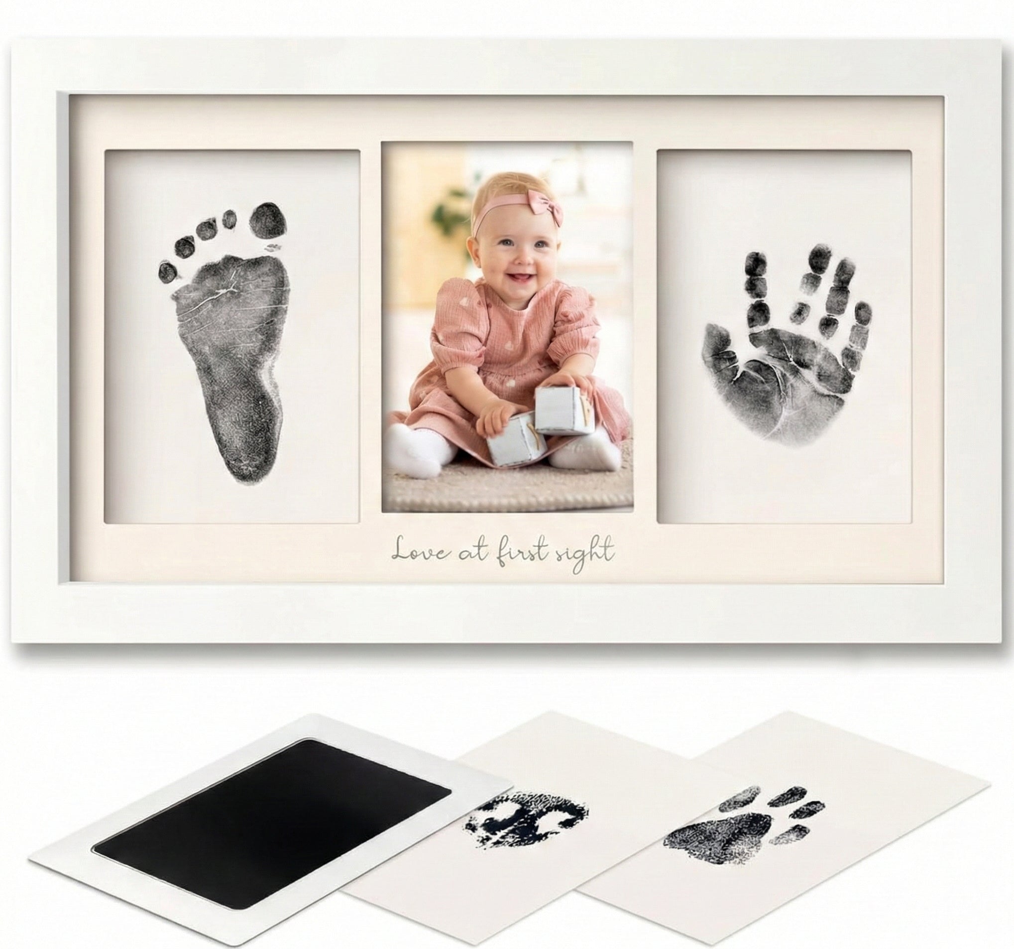 Baby hand and foot print frame with photo of a baby and ink pads.