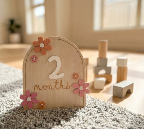 Kiddospot wooden baby milestone cards showing 2 months on nursery floor — photo prop 