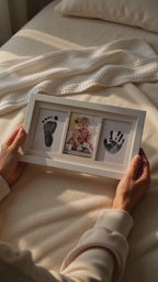 Vertical video of hands holding white triple-window inkless newborn print frame with mess-free inkless pad and print cards