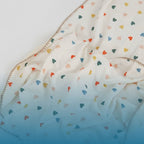 Kiddospot GOTS-certified organic cotton baby blanket in a scattered heart design, made from lightweight breathable muslin double-gauze measuring 120 x 150cm. 100% chemical-free from field to finished product, safe for newborn skin. Ideal baby shower gift. Free AU shipping. kiddospot.com.