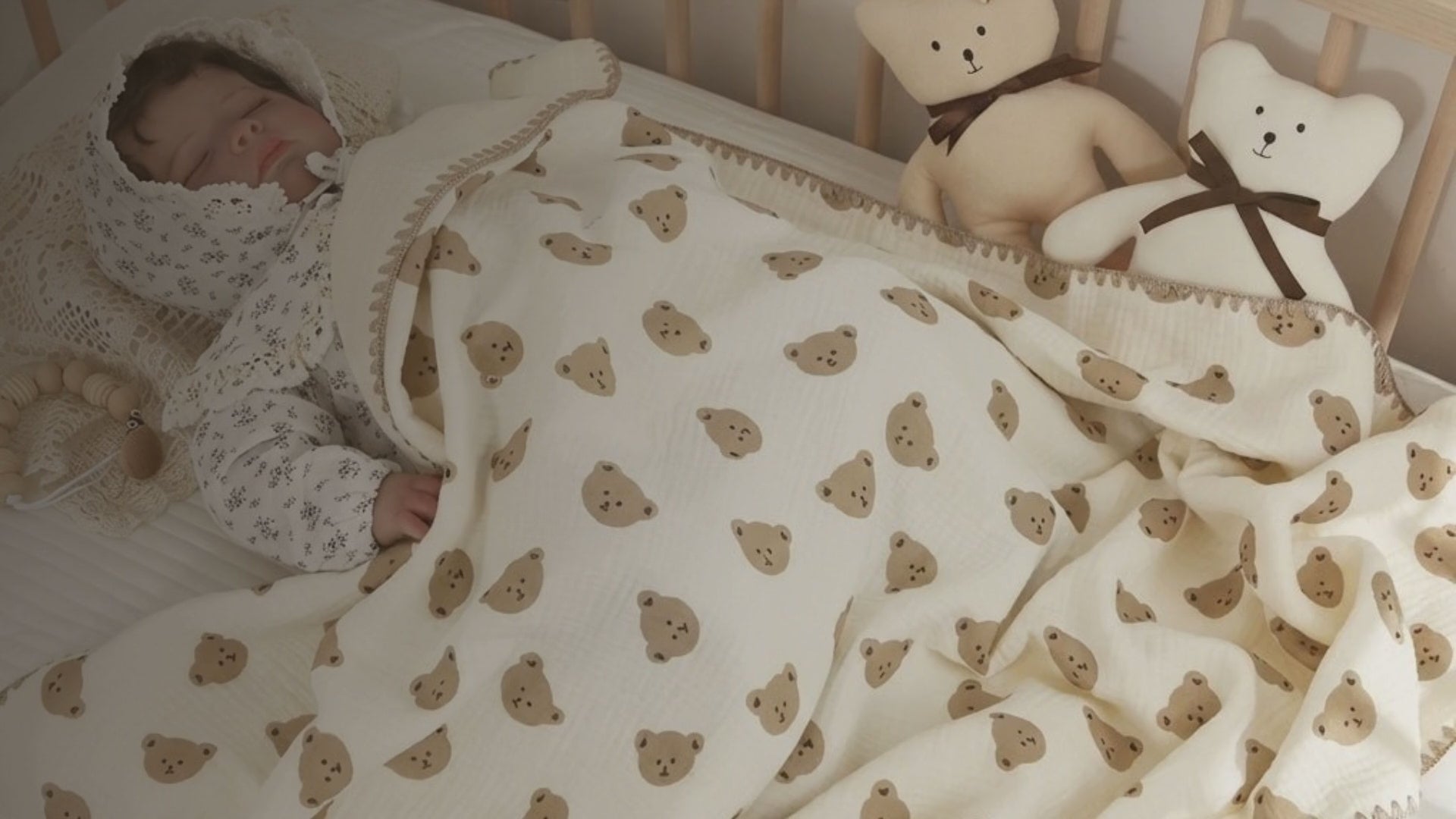 Kiddospot GOTS Certified Organic Cotton Baby Blanket in Bear Design — soft cream knitted blanket, 120x150cm, with a classic repeat teddy bear face pattern in warm taupe. 100% chemical-free organic cotton, breathable knit structure for natural temperature regulation. Gender-neutral design suited to Scandi, traditional, and boho nurseries. Grows with baby from newborn through toddler years. Free AU shipping. kiddospot.com
