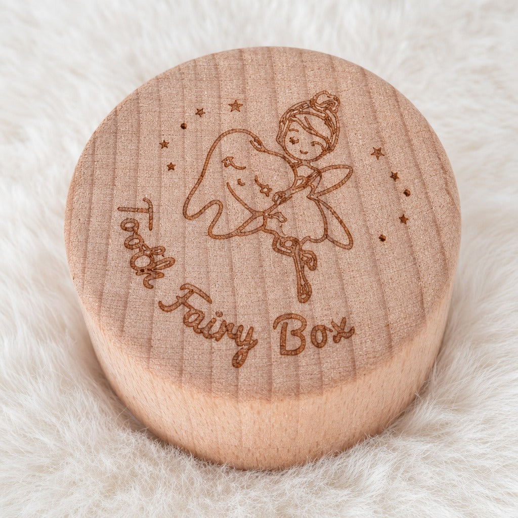 Kiddospot round wooden keepsake box lid engraved with a fairy holding a bell and the words 'Fairy Box,' placed on a soft white faux-fur surface.