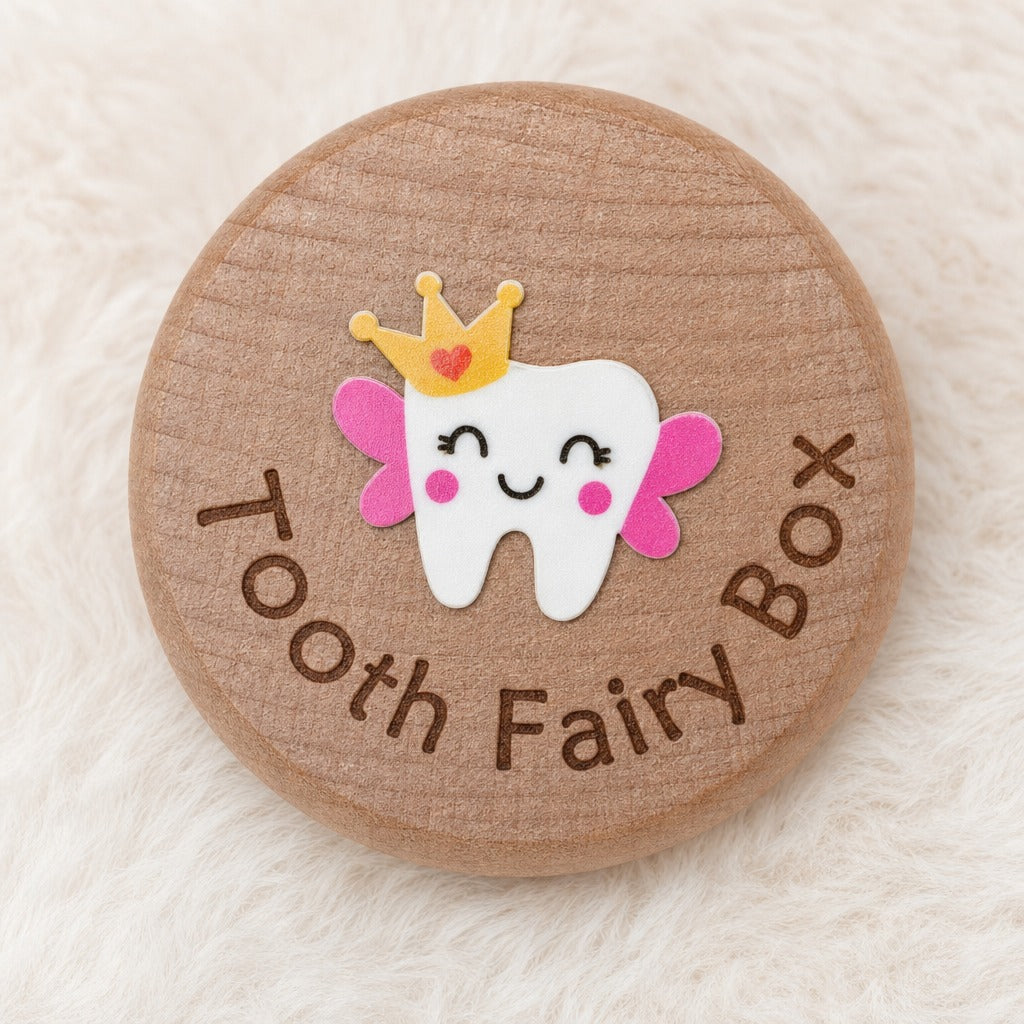 Kiddospot round wooden tooth fairy box lid with a cute cartoon tooth character wearing a gold crown and pink wings, surrounded by the words 'Tooth Fairy Box' in brown lettering, set on a soft white faux fur background.