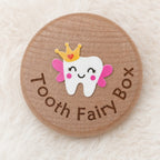 Kiddospot round wooden tooth fairy box lid with a cute cartoon tooth character wearing a gold crown and pink wings, surrounded by the words 'Tooth Fairy Box' in brown lettering, set on a soft white faux fur background.